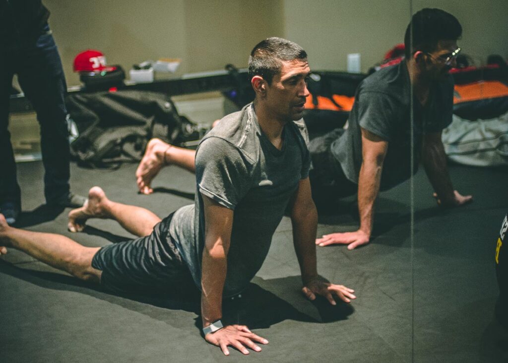 Man doing stretches in Brave MMA & Fitness gym