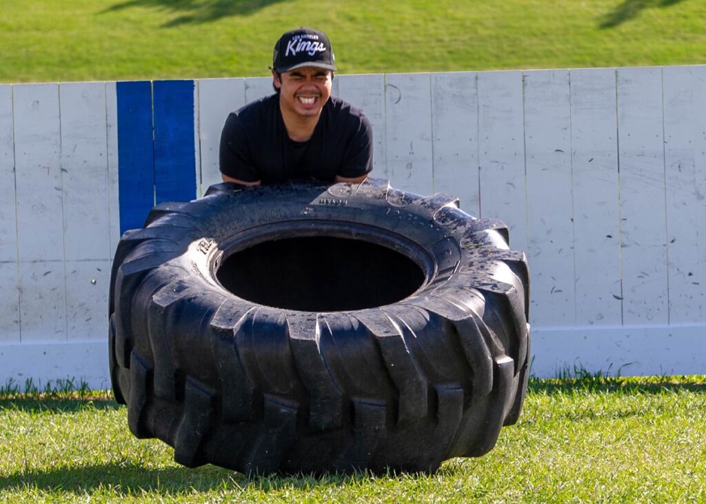 Man lifting a giant tire to improve strength