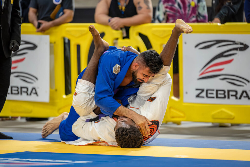 Two men on a mat in a Jiu Jitsu Competition