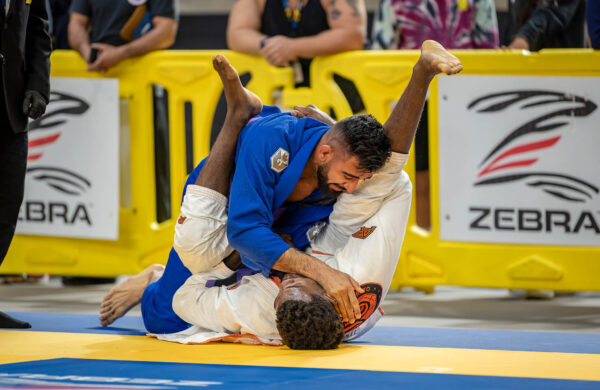 /Two men on a mat in a Jiu Jitsu Competition