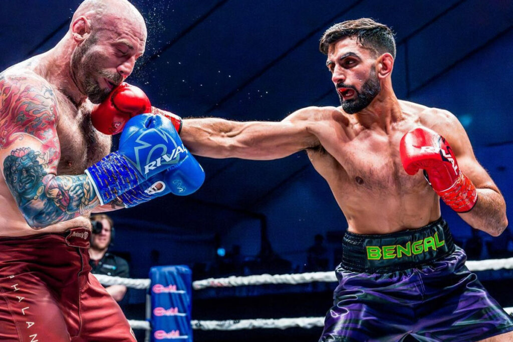 KB Bhullar in a boxing match punching his opponent in the face