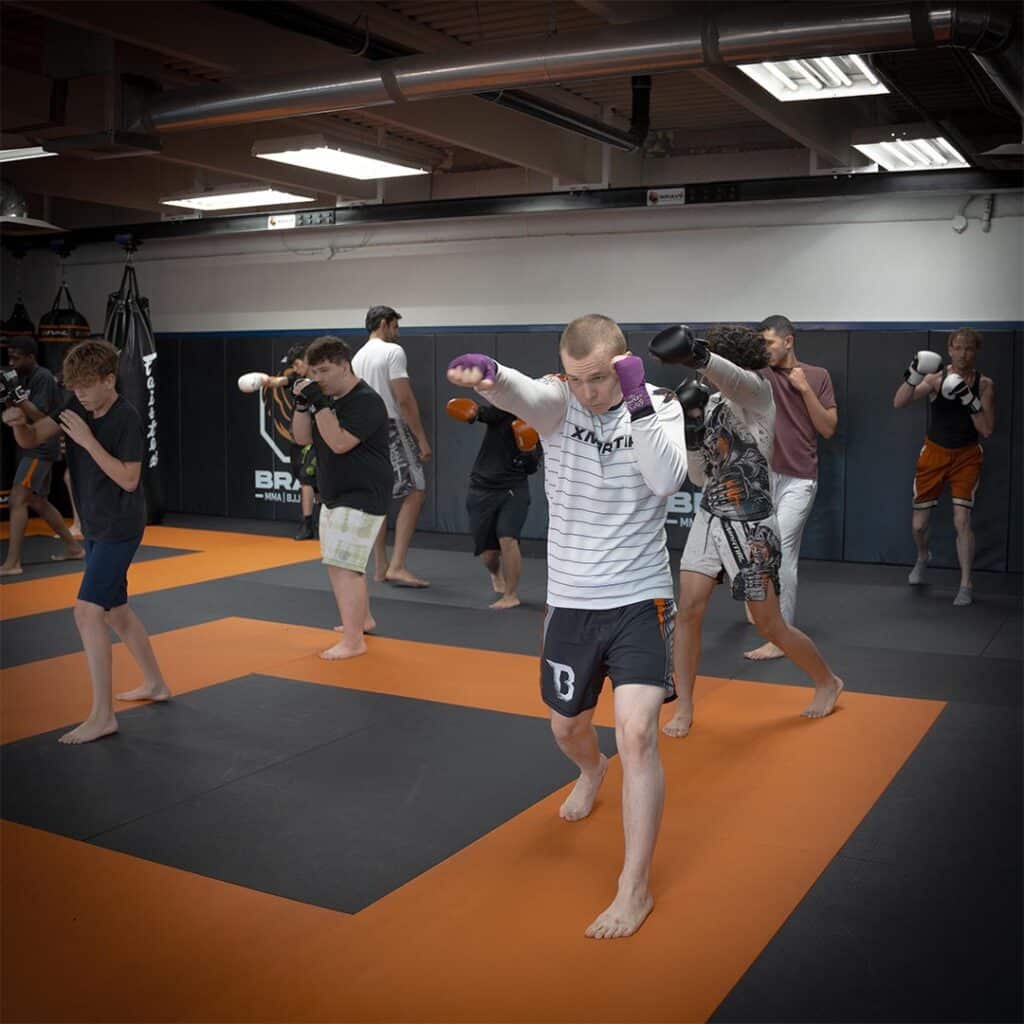 Kids and teens practicing boxing and MMA techniques at Bravé MMA and Fitness gym in Austin, Texas.