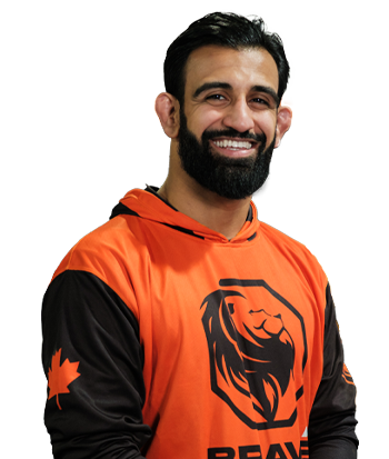 Male athlete smiling in sports jersey with lion logo.