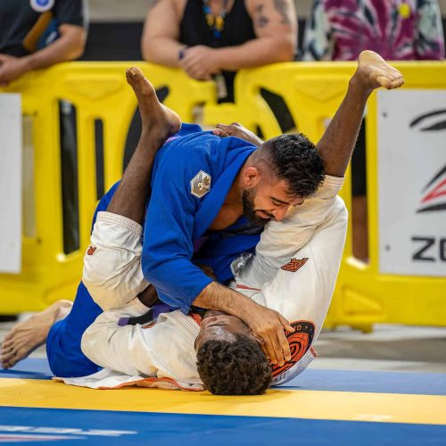 Two men on a mat in a Jiu Jitsu Competition